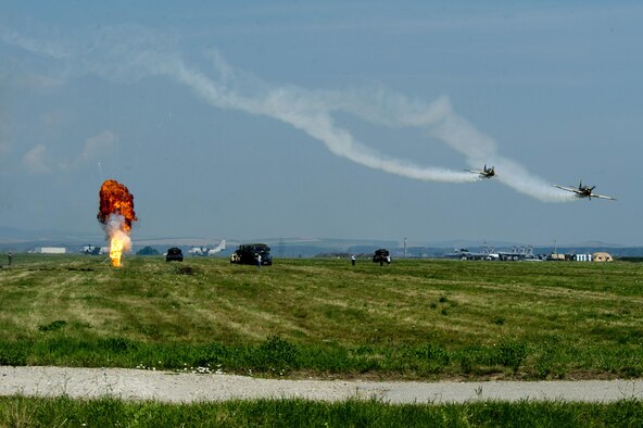 Two specialized Yakovlev Yak-52 trainer aircraft participate in a simulated bombing drill during the Romanian Air Force's 71st Air Base's air show and open house at Campia Turzii, Romania, July 23, 2016. (U.S. Air Force photo/Staff Sgt. Joe W. McFadden)