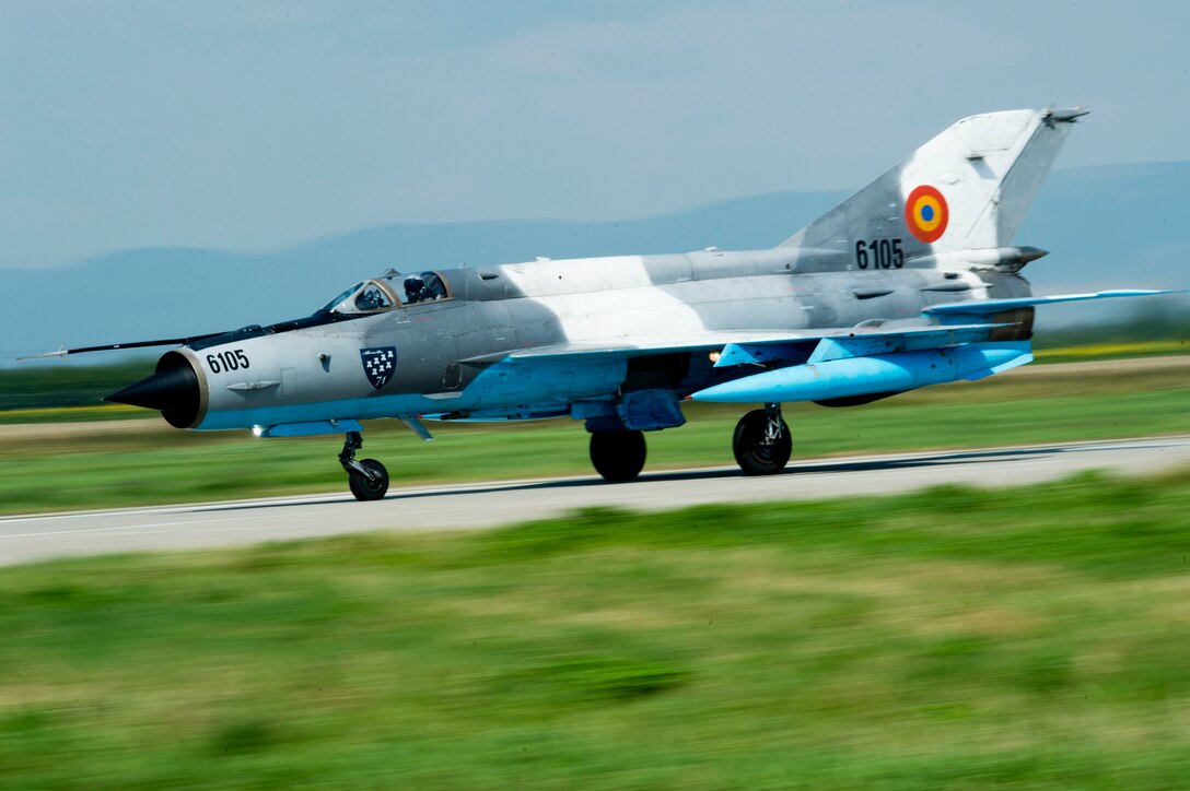 A Romanian air force MiG-21 LanceR fighter aircraft takes off from the flightline during the RoAF's 71st Air Base's air show and open house at Campia Turzii, Romania, July 23, 2016. The aviation demonstration took place during the middle of the U.S. Air Force's 194th Expeditionary Fighter Squadron's six-month long theater security package deployment to Europe in support of Operation Atlantic Resolve, which aims to bolster the U.S.'s continued commitment to the collective security of NATO and dedication to the enduring peace and stability in the region. The unit, comprised of more than 200 CANG Airmen from the 144th Fighter Wing at Fresno ANG Base, Calif., as well as U.S. Air Force Airmen from the 52nd Fighter Wing at Spangdahlem Air Base, Germany, piloted, maintained and supported the deployment of 12 F-15Cs Eagle fighter aircraft throughout nations like Romania, Iceland, the United Kingdom, the Netherlands, Estonia and among others. The F-15Cs took to the skies alongside the 71st AB's MiG-21 fighter aircraft and Puma helicopters for both the airshow, the second engagement of its kind at Campia Turzii under Operation Atlantic Resolve, and the bilateral flight training, also known as Dacian Eagle 2016. (U.S. Air Force photo by Staff Sgt. Joe W. McFadden/Released)