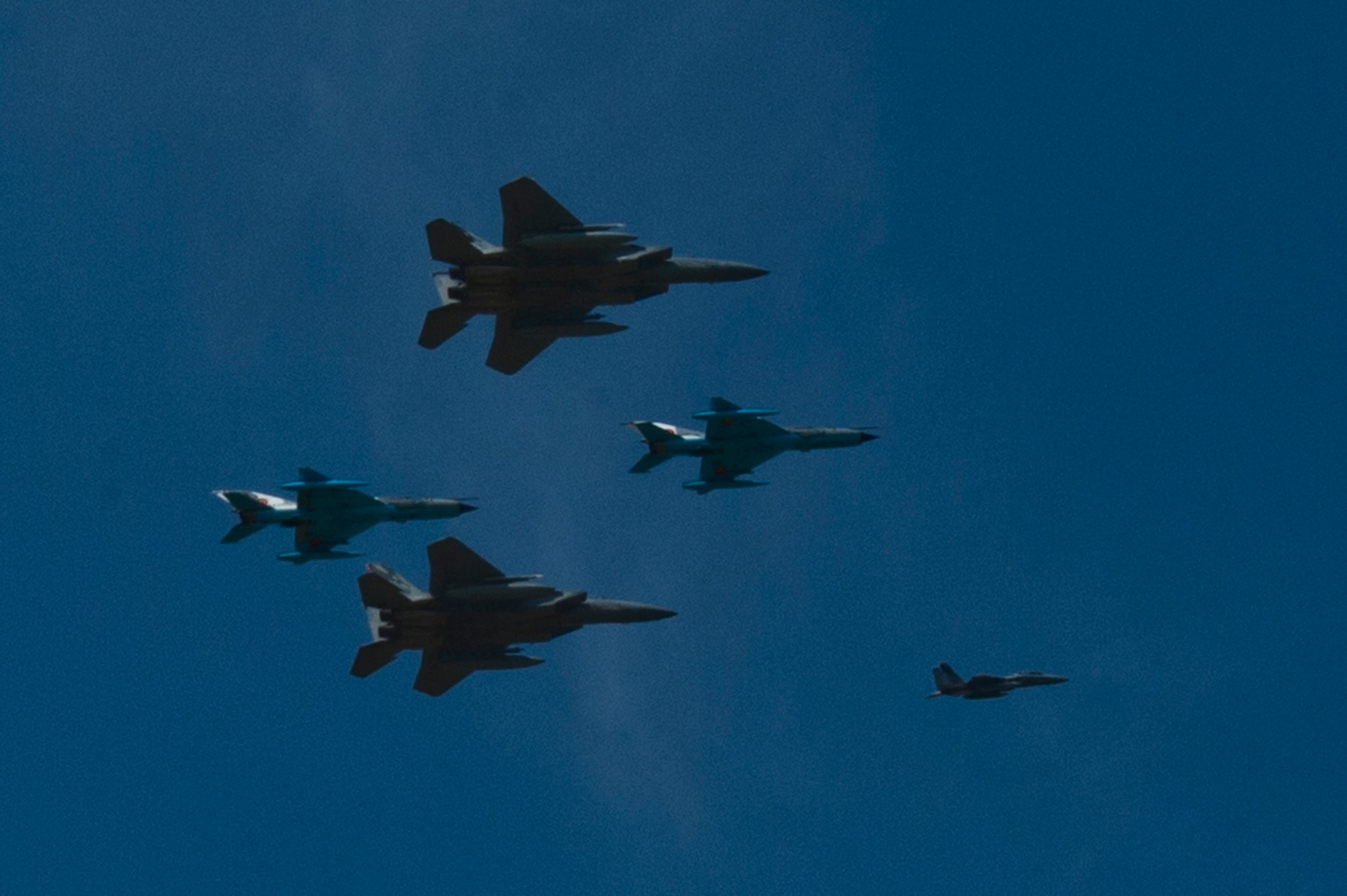 A flight formation of Romanian air force MiG-21 LanceR aircraft and U.S. Air Force F-15C Eagle fighter aircraft fly during the RoAF's 71st Air Base's air show and open house at Campia Turzii, Romania, July 23, 2016.  The aviation demonstration took place during the middle of the U.S. Air Force's 194th Expeditionary Fighter Squadron's six-month long theater security package deployment to Europe in support of Operation Atlantic Resolve, which aims to bolster the U.S.'s continued commitment to the collective security of NATO and dedication to the enduring peace and stability in the region. The unit, comprised of more than 200 CANG Airmen from the 144th Fighter Wing at Fresno ANG Base, Calif., as well as U.S. Air Force Airmen from the 52nd Fighter Wing at Spangdahlem Air Base, Germany, piloted, maintained and supported the deployment of 12 F-15Cs Eagle fighter aircraft throughout nations like Romania, Iceland, the United Kingdom, the Netherlands, Estonia and among others. The F-15Cs took to the skies alongside the 71st AB's MiG-21 fighter aircraft and Puma helicopters for both the airshow, the second engagement of its kind at Campia Turzii under Operation Atlantic Resolve, and the bilateral flight training, also known as Dacian Eagle 2016. (U.S. Air Force photo by Staff Sgt. Joe W. McFadden/Released)