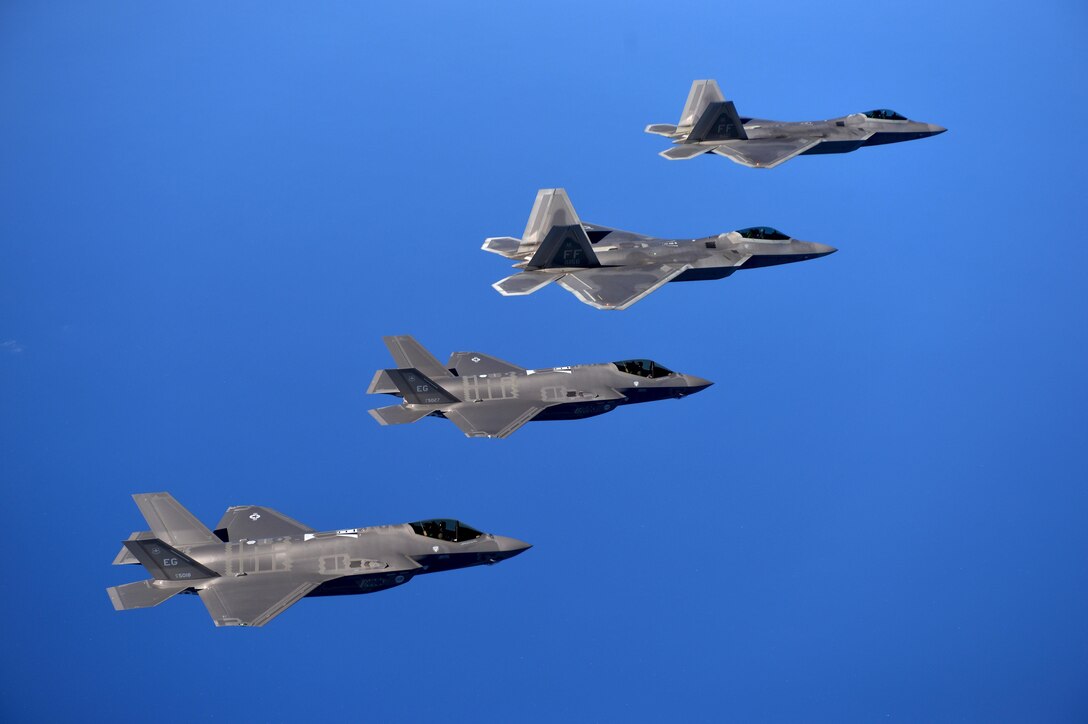 F-22 Raptors from the 94th Fighter Squadron, Joint Base Langley-Eustis, Va., and F-35A Lightning IIs from the 58th Fighter Squadron, Eglin Air Force Base, Fla., fly in formation after completing an integration training mission over the Eglin Training Range, Florida, Nov. 5, 2014. The purpose of the training was to improve integrated employment of fifth-generation assets and tactics. The F-35s and F-22s flew offensive counter air, defensive counter air and interdiction missions, maximizing effects by employing fifth-generation capabilities together. (U.S. Air Force photo/Master Sgt. Shane A. Cuomo)