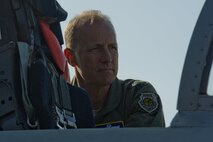 California Air National Guard Maj. Gen. Jon Kelk, both the ANG mobilization assistant to the U.S. Air Forces in Europe/Air Forces Africa commander and the commander, chief of staff of the CANG, looks inside the cockpit of an Massachusetts ANG F-15C Eagle fighter aircraft assigned to the 104th Fighter Wing, Barnes ANG Base, Mass., during the Romanian air force's 71st Air Base's air show and open house at Campia Turzii, Romania, July 23, 2016. The aviation demonstration took place during the middle of the U.S. Air Force's 194th Expeditionary Fighter Squadron's six-month long theater security package deployment to Europe in support of Operation Atlantic Resolve, which aims to bolster the U.S.'s continued commitment to the collective security of NATO and dedication to the enduring peace and stability in the region. The unit, comprised of more than 200 CANG Airmen from the 144th Fighter Wing at Fresno ANG Base, Calif., as well as U.S. Air Force Airmen from the 52nd Fighter Wing at Spangdahlem Air Base, Germany, piloted, maintained and supported the deployment of 12 F-15Cs Eagle fighter aircraft throughout nations like Romania, Iceland, the United Kingdom, the Netherlands, Estonia and among others. The F-15Cs took to the skies alongside the 71st AB's MiG-21 fighter aircraft and Puma helicopters for both the airshow, the second engagement of its kind at Campia Turzii under Operation Atlantic Resolve, and the bilateral flight training, also known as Dacian Eagle 2016. The 194th EFS partnered with the 104th EFS's previous deployment as part of the theater security package, including a contingent of 104th FW aircraft which remained at Campia Turzii. (U.S. Air Force photo by Staff Sgt. Joe W. McFadden/Released)