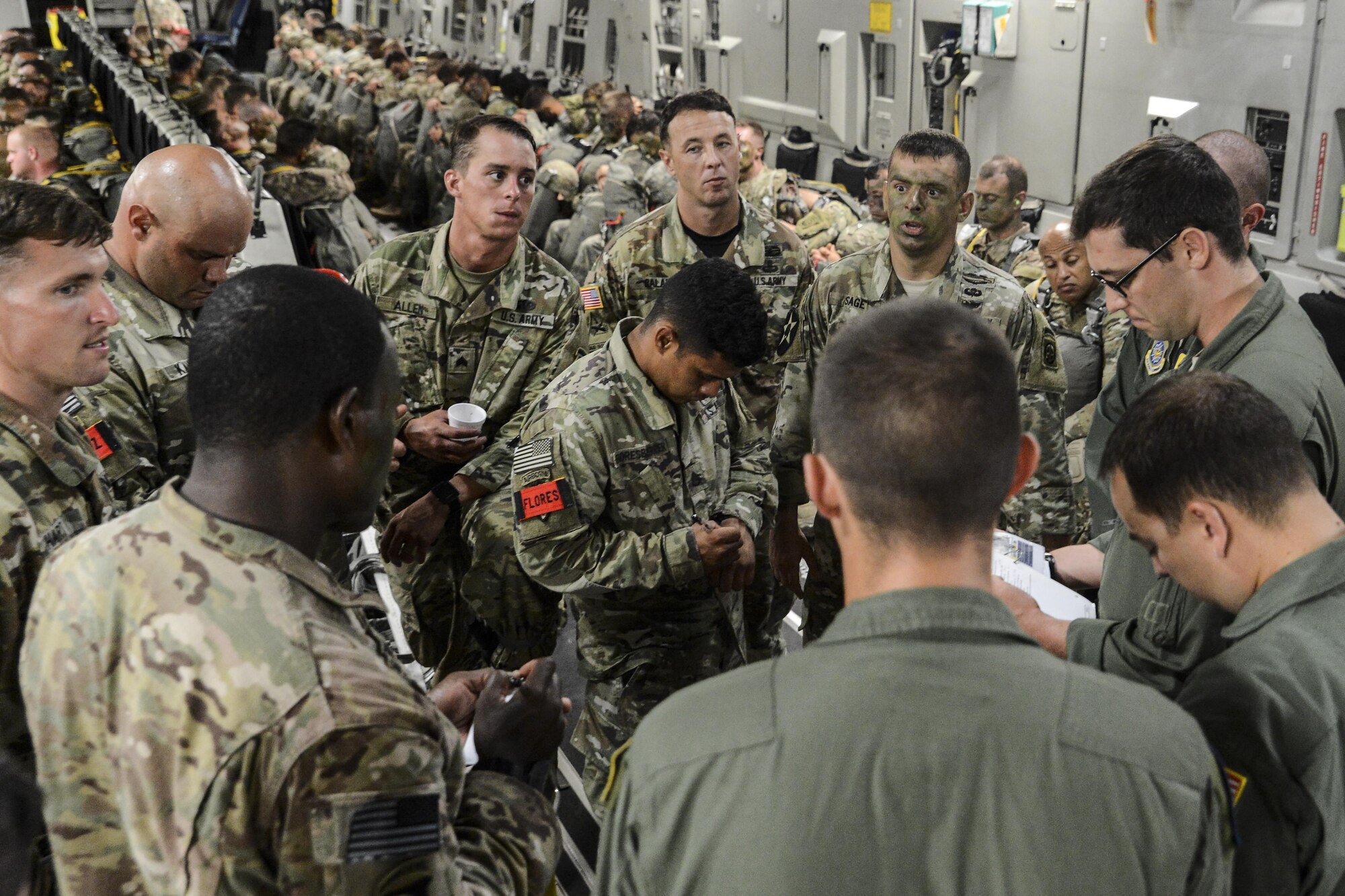 Paratroopers from the 82nd Airborne Division, along with C-17 Globemaster III aircrew members from Joint Base Charleston, S.C., discuss logistics prior to an airdrop July 16, 2016, at Pope Army Airfield, N.C. More than 700 paratroopers dropped into Polk Field, La., from Air Mobility Command C-17s and C-130 Hercules aircraft as part of the Emergency Deployment Readiness Exercise, called Devil Strike. (U.S. Air Force photo by Tech. Sgt. Sean Tobin)