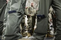 Paratroopers from the 82nd Airborne Division, along with C-17 Globemaster III aircrew members from Joint Base Charleston, S.C., discuss logistics prior to an airdrop July 16, 2016, at Pope Army Airfield, N.C. More than 700 paratroopers dropped into Polk Field, La., from Air Mobility Command C-17s and C-130 Hercules aircraft as part of the Emergency Deployment Readiness Exercise, called Devil Strike. (U.S. Air Force photo by Tech. Sgt. Sean Tobin)