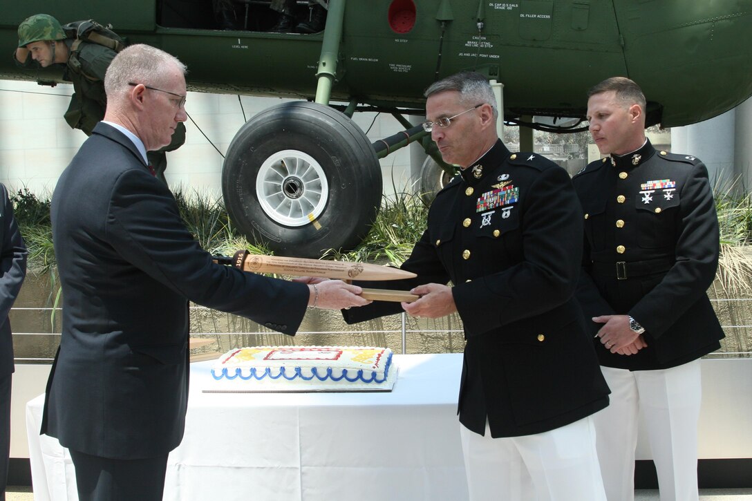 Bill Miller, director of the Diplomatic Security Service (DSS), and Brig. Gen. Christopher Mahoney, director of the Strategy and Plans Division for Plans, Policies and Procedures, exchange ceremonial rudae at a celebration of the centennial of the DSS and 70th anniversary of the Marine Security Guard program, June 29 at the National Museum of the Marine Corps. While the MSG program has only formally existed for 70 years, Marines have been guarding U.S. diplomatic interests since the early years of the country. 