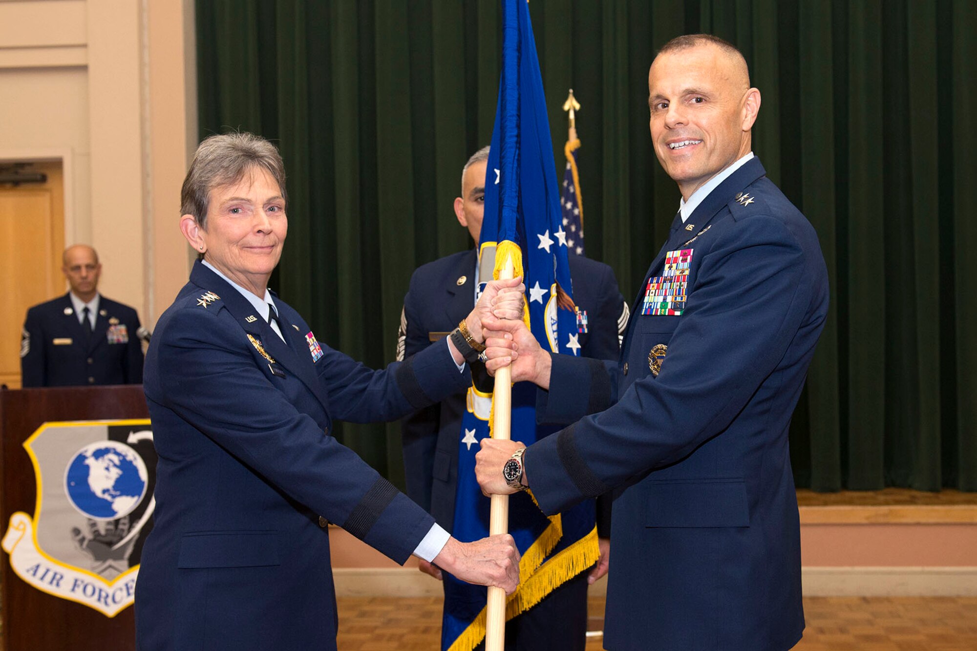Maj. Gen. Bradley Spacy receives the unit flag from Gen. Ellen Pawlikowski, commander of Air Force Materiel Command, to become commander of the Air Force Installation and Mission Support Center July 22 in a ceremony at the Gateway Club, Joint Base San Antonio-Lackland, Texas. (U.S. Air Force Photo by Staff Sgt. Marissa Garner)