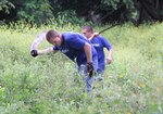 New Mexico National Guard Spc. Justin Langlitz and Spc. Xavier Romero participate in area beautification at the site of a future school for the community of Cuajiniquil July 20, 2016. Langlitz and Romero are members of 1st  Platoon, 919th  Military Police Company, New Mexico National Guard which were guests at the Escuela Nacional de Policía in nearby Murciélago for their Annual Training. The project was part of their community improvement day.