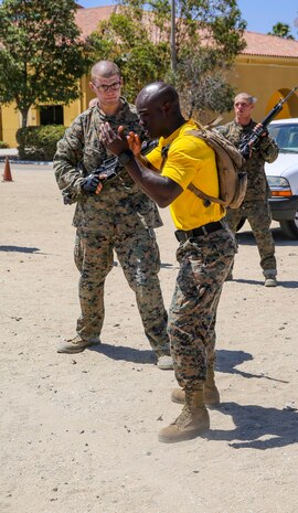 A drill instructor from Fox Company, 2nd Recruit Training Battalion, demonstrates how to properly execute a technique during a Marine Corps Martial Arts Program class at Marine Corps Recruit Depot San Diego, July 13. Drill instructors walked around during the training session to make sure each recruit was executing the technique correctly. Recruits can use this time to ask drill instructors questions if they are unsure of how to properly conduct the moves. Annually, more than 17,000 males recruited from the Western Recruiting Region are trained at MCRD San Diego. Fox Company is scheduled to graduate Sept. 23.
