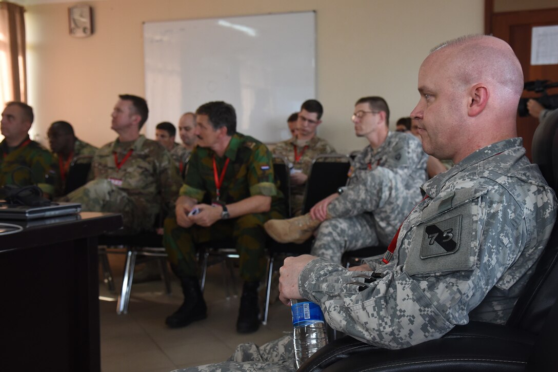 DAR ES SALAAM, Tanzania - U.S. Army Lt. Col. Andrew Rish, 75th Training Command and Eastern Accord 2016 after action report and evaluation coordinator, attends an after action report meeting at the end of the command post exercise, July 21, 2016, at the Tanzanian Peacekeeping Training Centre, in Dar es Salaam, Tanzania. EA16 is an annual, combined, joint military exercise that brings together partner nations to practice and demonstrate proficiency in conducting peacekeeping operations. (U.S. Air Force photo by Staff Sgt. Tiffany DeNault)
