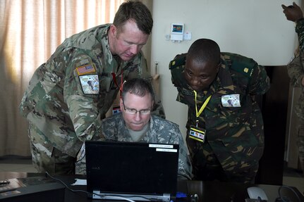 DAR ES SALAAM, Tanzania – Eastern Accord 2016 senior military leaders review after action report slides before briefing the training audience at the end of the command post exercise, July 21, 2016, at the Tanzanian Peacekeeping Training Centre, in Dar es Salaam, Tanzania. EA16 is an annual, combined, joint military exercise that brings together partner nations to practice and demonstrate proficiency in conducting peacekeeping operations. (U.S. Air Force photo by Staff Sgt. Tiffany DeNault)