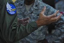 California Air National Guard Maj. Gen. Jon Kelk, both the ANG mobilization assistant to the U.S. Air Forces in Europe/Air Forces Africa commander and the commander, chief of staff of the CANG, makes a point while speaking to Airmen assigned to the 194th Expeditionary Fighter Squadron during the Romanian air force's 71st Air Base's air show and open house at Campia Turzii, Romania, July 23, 2016. The aviation demonstration took place during the middle of the 194th EFS' six-month long theater security package deployment to Europe in support of Operation Atlantic Resolve, which aims to bolster the U.S.'s continued commitment to the collective security of NATO and dedication to the enduring peace and stability in the region. The unit, comprised of more than 200 CANG Airmen from the 144th Fighter Wing at Fresno ANG Base, Calif., as well as U.S. Air Force Airmen from the 52nd Fighter Wing at Spangdahlem Air Base, Germany, piloted, maintained and supported the deployment of 12 F-15Cs Eagle fighter aircraft throughout nations like Romania, Iceland, the United Kingdom, the Netherlands, Estonia and among others. The F-15Cs took to the skies alongside the 71st AB's MiG-21 fighter aircraft and Puma helicopters for both the airshow, the second engagement of its kind at Campia Turzii under Operation Atlantic Resolve, and the bilateral flight training, also known as Dacian Eagle 2016. (U.S. Air Force photo by Staff Sgt. Joe W. McFadden/Released)