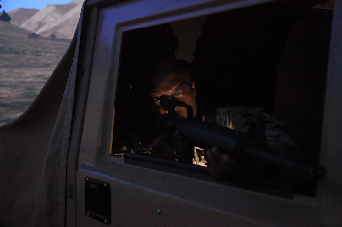 U.S. Army Sgt. John Jones, assigned to the 982nd Combat Camera, simulates shooting M-16 rifle during convoy training for annual training at Fort Bragg, NC on July 18, 2016. AT is a mandatory training requirement that is part of the statutory obligation when assigned to the U.S. Army Reserves. (U.S. Army photo by Spc. Lisa Velazco/Released)