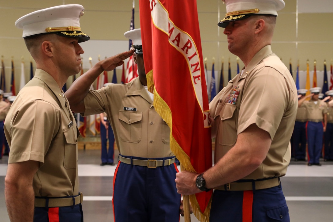 U.S. Marine Corps Maj. Paul B. Bock, right, prepares to give the organizational colors to U.S. Marine Corps Maj. Luke A. Sauber during Recruiting Station Frederick’s change of command ceremony June 28, 2016 at Fort Detrick. The passing of the colors signifies a formal transfer of authority and responsibility from one commanding officer to another. Bock is the outgoing commanding officer of the recruiting station, while Sauber is the incoming commanding officer.