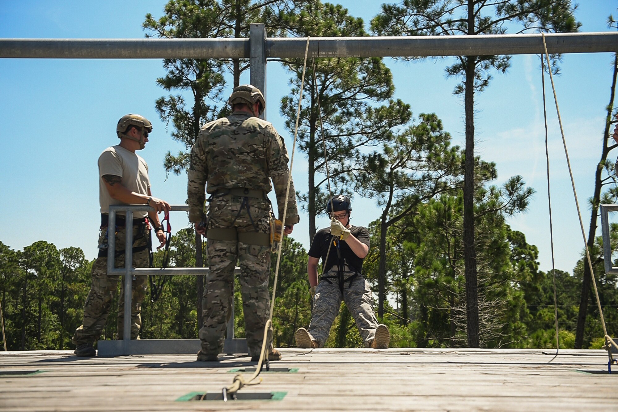 Special Tactics Airmen encourage a junior ROTC cadet rappelling down a 40-foot wall normally used for training on rescue and infiltration techniques at Hurlburt Field, Fla., July 20, 2016. Special Tactics Airmen partnered with 60 cadets from five local high schools for a week-long Summer Leadership Course, teaching leadership, teamwork and self-confidence. (U.S. Air Force photo by Senior Airman Ryan Conroy)