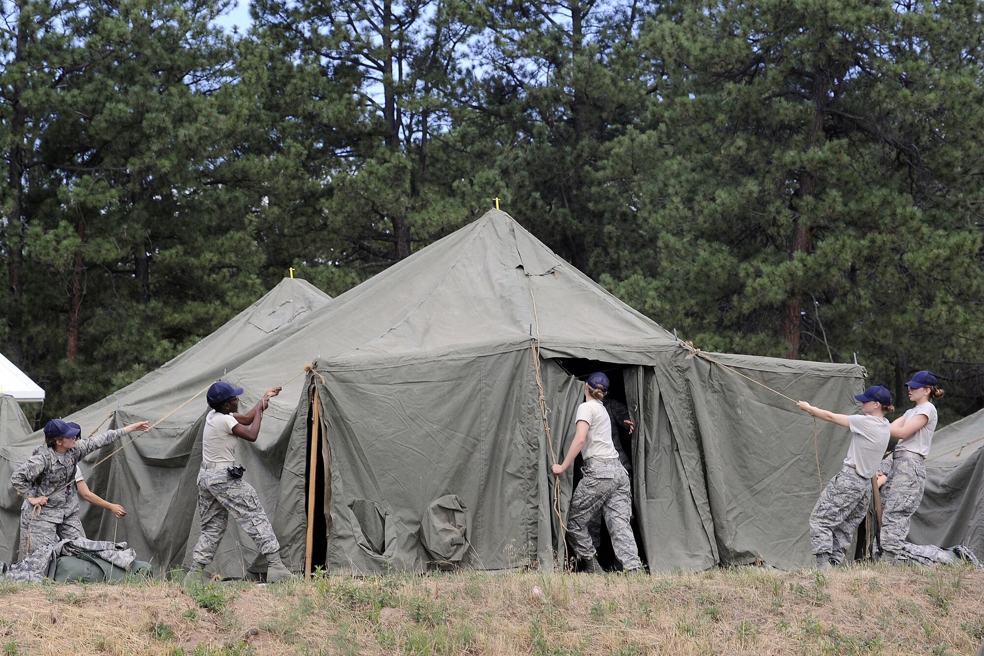 Cadet trainees complete the first task of building their living tents upon arrival at Jacks Valley July 24, 2016. Cadet trainees will spend 11 days going through several courses that will test their teamwork, mental fortitude and fears. (U.S. Air Force photo by Mike Kaplan)