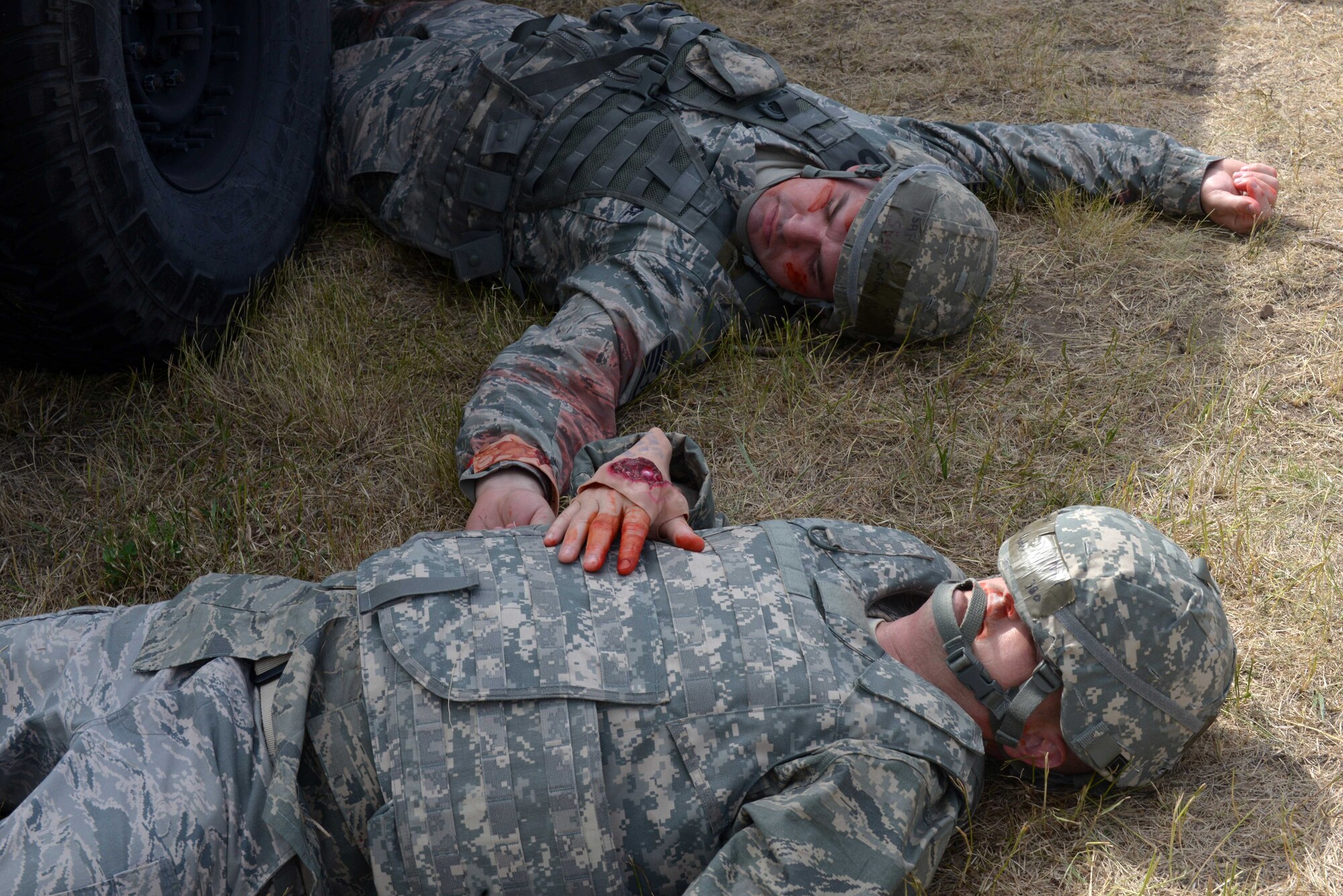 The 28th Civil Engineer Squadron Airmen volunteer as casualties at the Self Aid Buddy Care (SABC) station during the Prime Base Engineer Emergency Force (BEEF) challenge at Ellsworth Air Force Base, S.D., July 22, 2016. Prime BEEF teams consist of 28th Civil Engineer Squadron personnel who are organized, equipped and trained to respond within hours to worldwide emergencies and to support the Air Force's mission with base build-up, sustainment and recovery operations. (U.S. Air Force photo by Airman Donald Knechtel) 
