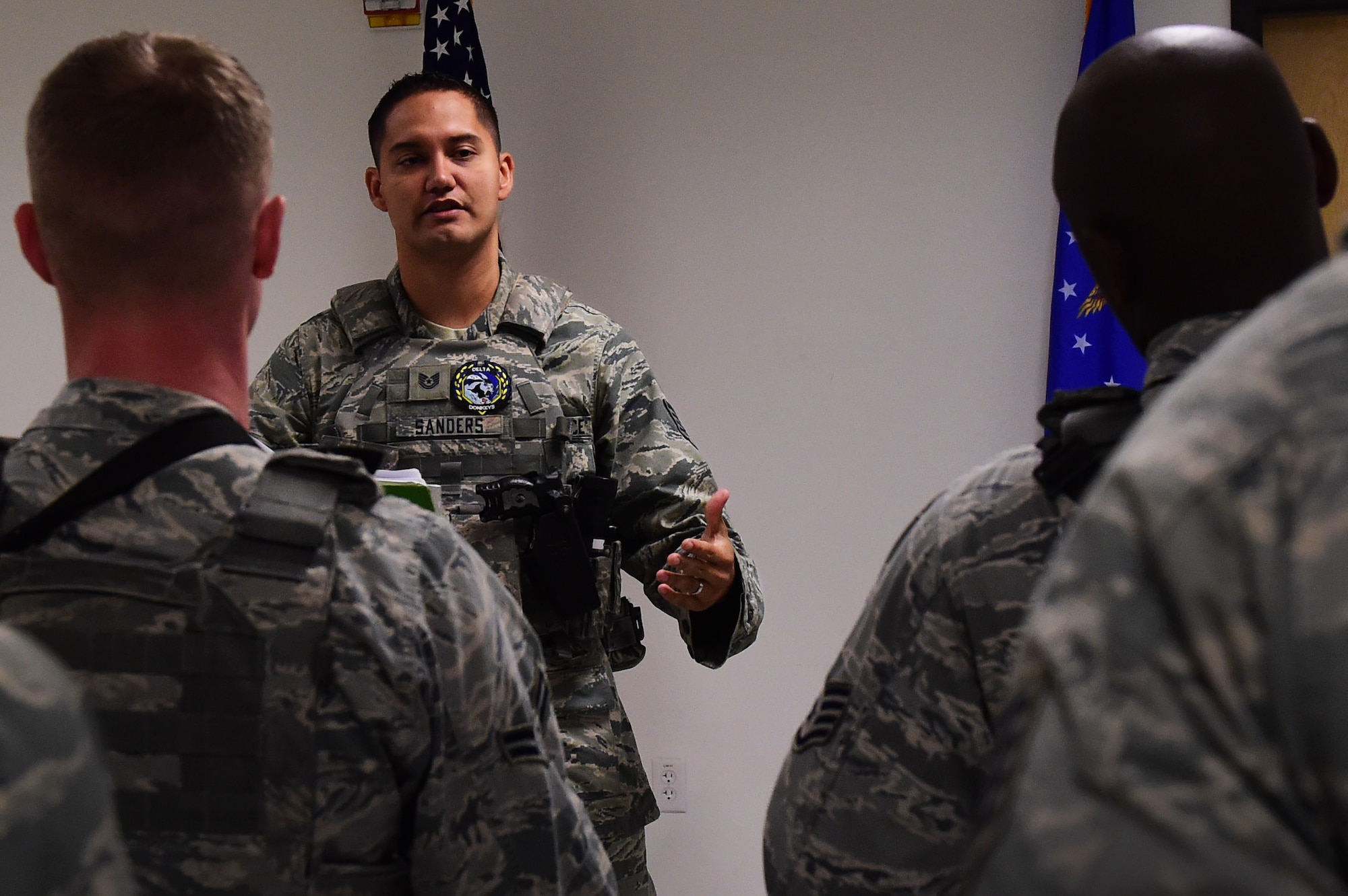 Tech. Sgt. Daniel Sanders, 460th Space Wing Security Forces Squadron flight chief, speaks to fellow defenders during a shift change July 19, 2016, at Buckley Air Force Base, Colo. The breakdown of what has happened since their last shift helps defenders prepare for situations that may come up and also provides supervision to the opportunity to check on their Airmen. (U.S. Air Force photo by Airman 1st Class Gabrielle Spradling/Released) 
