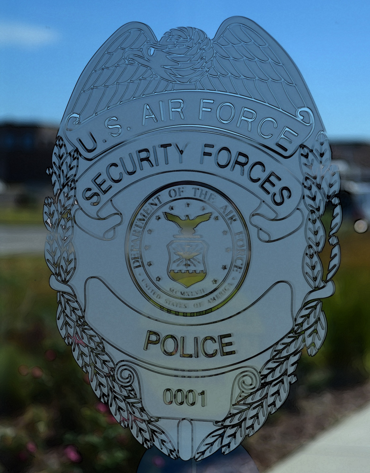Members of the 460th Space Wing Security Forces Squadron display their badge on their building July 20, 2016, at Buckley Air Force Base, Colo. Security Forces, one of the largest career fields in the Air Force, have responsibilities that include missile security, defending military installations around the world, installation law enforcement, combat arms and handling military working dogs. (U.S. Air Force photo by Airman 1st Class Gabrielle Spradling/Released)