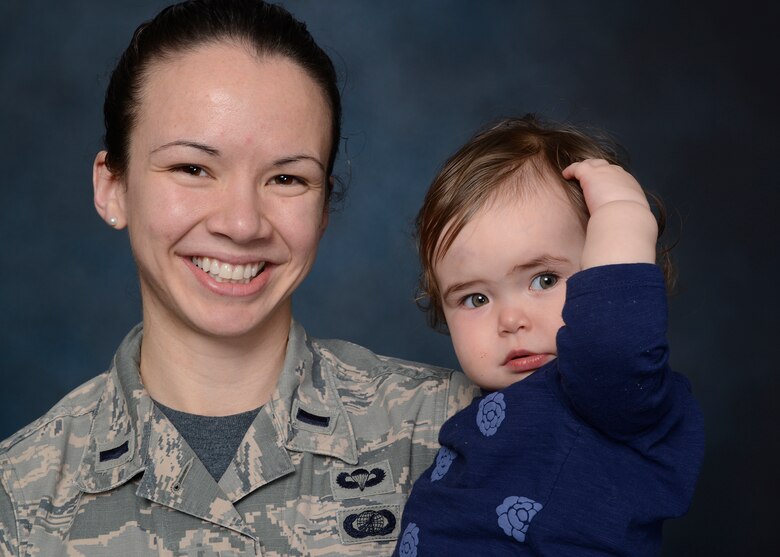 1st Lt. Deanna Kerkhoff, 341st Contracting Squadron contracting officer, poses with daughter, Claire, February 26, 2016, at Malmstrom Air Force Base, Mont. Claire is 20 months old, is surrounded by supporters and already proves resilient in the face of adversity. (U.S. Air Force photo/Beau Wade)