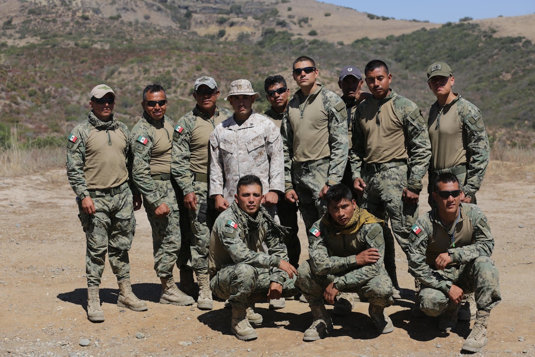 U.S. Marine Corps Sgt. Daniel Posada, a Spanish interpreter for Mexican service members, poses for a group photo with Mexican special forces aboard Marine Corps Base Camp Pendleton, Calif., July 14, 2016. Marines were sharing their basic breach-and-clear tactics with Mexican service members during Rim of the Pacific 2016 in order to build trust and strengthen future coalition-force cohesion. Twenty-six nations, more than 40 ships and submarines, more than 200 aircraft and 25,000 personnel are participating in RIMPAC from June 30 to Aug. 4, in and around the Hawaiian Islands and Southern California. The world's largest international maritime exercise, RIMPAC provides a unique training opportunity that helps participants foster and sustain the cooperative relationships that are critical to ensuring the safety of sea lanes and security on the world's oceans. RIMPAC 2016 is the 25th exercise in the series that began in 1971. 