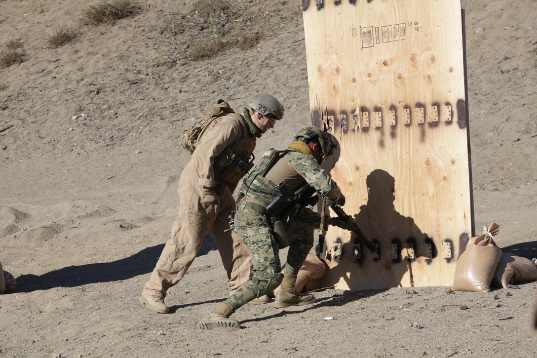 A U.S. Marines from Bravo Company, 1st Reconnaissance Battalion, runs a service member from Mexican special forces through a drill in utilizing firearms to breach a door aboard Marine Corps Base Camp Pendleton, Calif., July 14, 2016. Marines were sharing their basic breach-and-clear tactics with Mexican service members during Rim of the Pacific 2016 in order to build trust and strengthen future coalition-force cohesion. Twenty-six nations, more than 40 ships and submarines, more than 200 aircraft and 25,000 personnel are participating in RIMPAC from June 30 to Aug. 4, in and around the Hawaiian Islands and Southern California. The world's largest international maritime exercise, RIMPAC provides a unique training opportunity that helps participants foster and sustain the cooperative relationships that are critical to ensuring the safety of sea lanes and security on the world's oceans. RIMPAC 2016 is the 25th exercise in the series that began in 1971. 