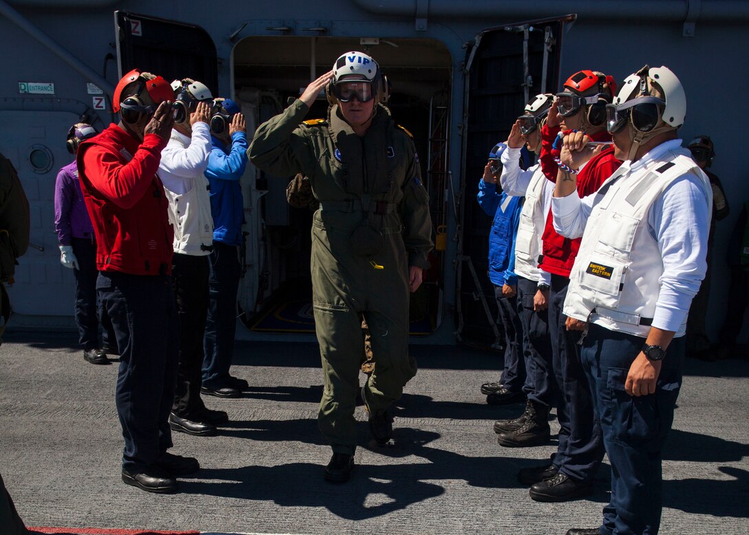 160714-M-OI464-045 PACIFIC OCEAN (July 14, 2016) – Commodore Jim Gilmour is saluted by Sailors from the Aviation Department of USS America while walking across the flight line. Gilmour is the commander of Combined Task Force 176. Twenty-six nations, more than 40 ships and submarines, more than 200 aircraft and 25,000 personnel are participating in RIMPAC from June 30 to Aug. 4, in and around the Hawaiian Islands and Southern California. The world’s largest international maritime exercise, RIMPAC provides a unique training opportunity that helps participants foster and sustain the cooperative relationships that are critical to ensuring the safety of sea lanes and security on the world's oceans. (U.S. Marine Corps photo by Staff Sgt. Chris Giannetti)