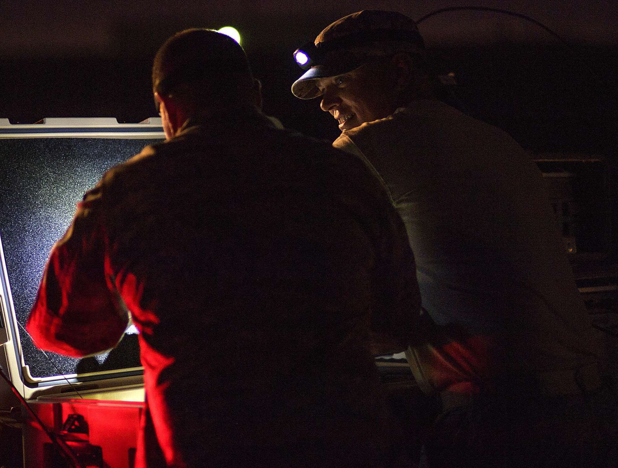 From right, Senior Master Sgt. Thomas Arns, 527 Space Aggressor Squadron, cracks a smile while undergoing proficiency training given by Capt. Brian Goodman July 20, 2016 at Nellis Air Force Base, Nevada during exercise Red Flag. Red Flag 16-3 is aimed at teaching service members how to integrate air, space and cyberspace elements. (U.S. Air Force photo/Tech. Sgt. David Salanitri)