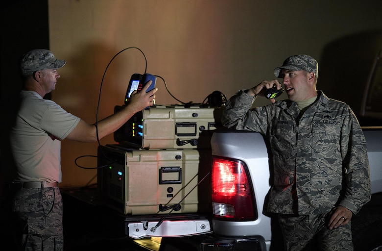 From left, Senior Master Sgt. Thomas Arns, 527 Space Aggressor Squadron, monitors a frequency instrument while coworker, Capt. Brian Goodman, communicates that they are ready to test a fighter squadron's GPS capability July 20, 2016 at Nellis Air Force Base, Nevada during exercise Red Flag. The space aggressors conduct training mission to educate forces on how to identify threats and mitigate their effects. (U.S. Air Force photo/Tech. Sgt. David Salanitri)