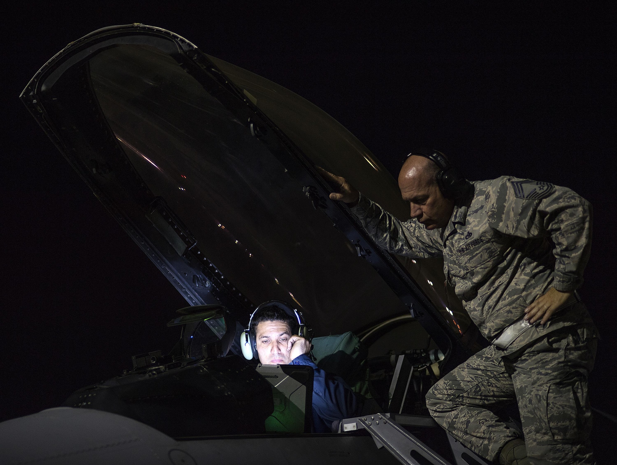 From left, Staff Sgt. Erick Vega, an avionics specialist with the 555th Fighter Squadron out of Aviano Air Base, Italy, attempts to figure out why the space systems on his F-16 Fighting Falcon aren't working correctly, while Chief Master Sgt. Tony Russell, a Red Flag Inspector General evaluator, observers. Airmen from the 527th Space Aggressor Squadron attempt to challenge Red Flag participants by posing attacks on space assets, simulating a potential attack by the enemy. "We challenge space forces to get better. And they do," said Capt. Brian Goodman, 527th SAG.  (U.S. Air Force photo/Tech. Sgt. David Salanitri)