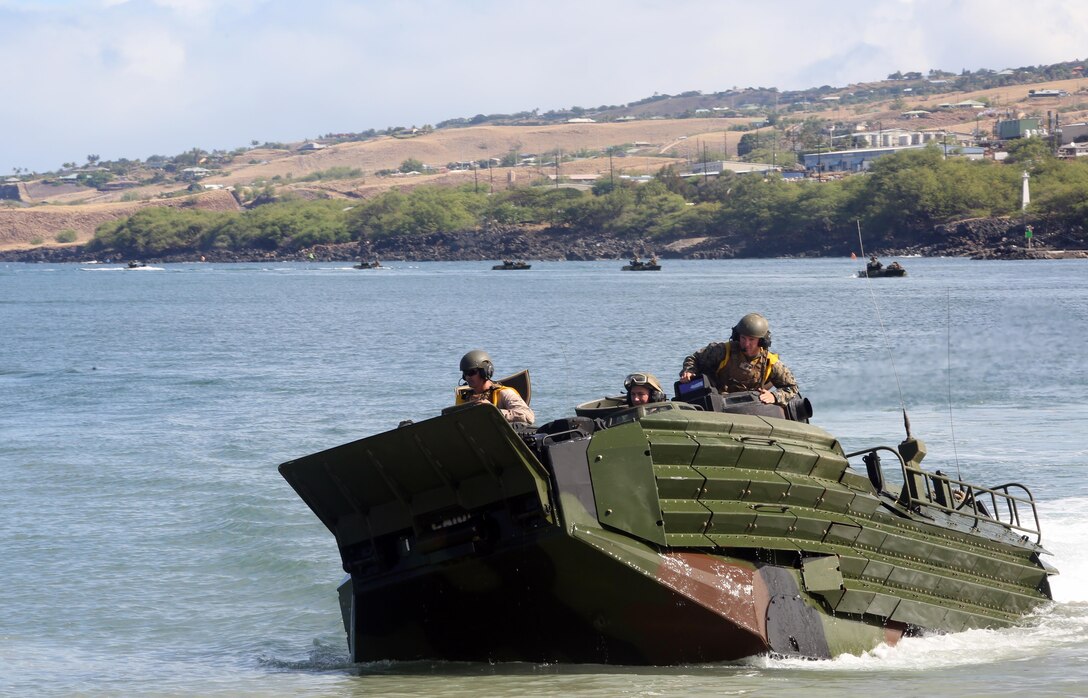 1st Lt. Josh Cuyler, right, and Staff Sgt. Steven Tholen, left, guide their Assault Amphibious Vehicle from USS San Diego to Kawaihae Pier, Hawaii, July 15,2016. The Marines are participating in Rim of the Pacific 2016, a multinational military exercise, from June 29 to Aug. 4 in and around the Hawaiian Islands. Cuyler and Tholen support III Marine Expeditionary Force, which trains year-round with U.S. partners in the Pacific Region. Cuyler, a native of Rochester, New York, is a platoon commander with Echo Company, 2nd Battalion, 3rd Marine Regiment. Tholen, a Boston native, is a section leader with AAV Platoon, Combat Assault Co., 3rd Marines. (U.S. Marine Corps Photo by Staff Sgt. Jesse R. Stence)