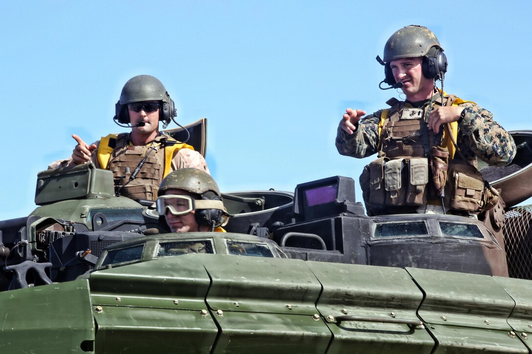 1st Lt. Josh Cuyler, right, and Staff Sgt. Steven Tholen, left, guide their Amphibious Assault Vehicle from the USS San Diego to Kawaihae Pier, Hawaii, July 15,2016. The Marines are participating in Rim of the Pacific 2016, a multinational military exercise, from June 29 to Aug. 4 in and around the Hawaiian Islands. Cuyler and Tholen support III Marine Expeditionary Force, which trains year-round with U.S. partners in the Pacific Region. Cuyler, a native of Rochester, New York, is a platoon commander with Echo Company, 2nd Battalion, 3rd Marine Regiment. Tholen, a Boston native, is a section leader with AAV Platoon, Combat Assault Co., 3rd Marines. (U.S. Marine Corps Photo by Staff Sgt. Jesse R. Stence)