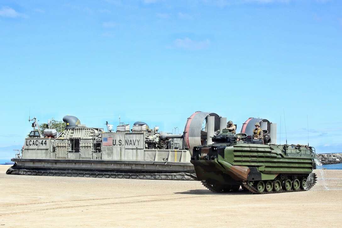 160715-M-UK649-045 KAWAIHAE, Hawaii (July 15, 2016) – U.S. Marines come ashore, via Assault Amphibious Vehicles and U.S. Navy Landing Craft Air Cushion hovercraft, at Kawaihae Pier, Hawaii, July 15, 2016. The Marines are participating in Rim of the Pacific 2016, a multinational military exercise, from June 29 to Aug. 4 in and around the Hawaiian Islands. Marines are knick-named “Soldiers of the Sea” because they are specially trained to integrate with the Navy to conduct expeditionary, amphibious operations, which  RIMPAC 16 simulates. (U.S. Marine Corps Photo by Staff Sgt. Jesse R. Stence)
