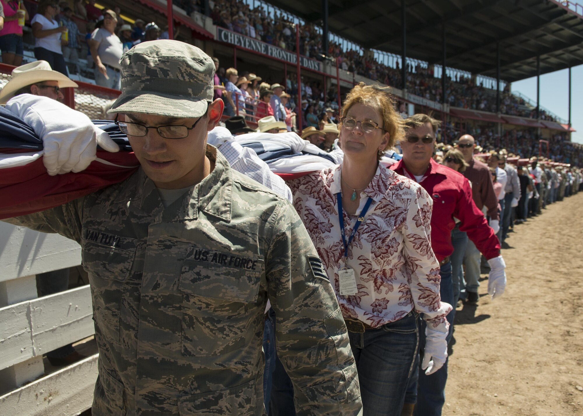 Staff Sgt. Christopher Van Tuyl, 90th Logistics Readiness Squadron member, carries the US flag across Frontier Park during Military Monday in Cheyenne, Wyo., July 25, 2016. Over 100 volunteers, both military and civilian, worked together to handle the flag. (U.S. Air Force photo by Senior Airman Malcolm Mayfield)
