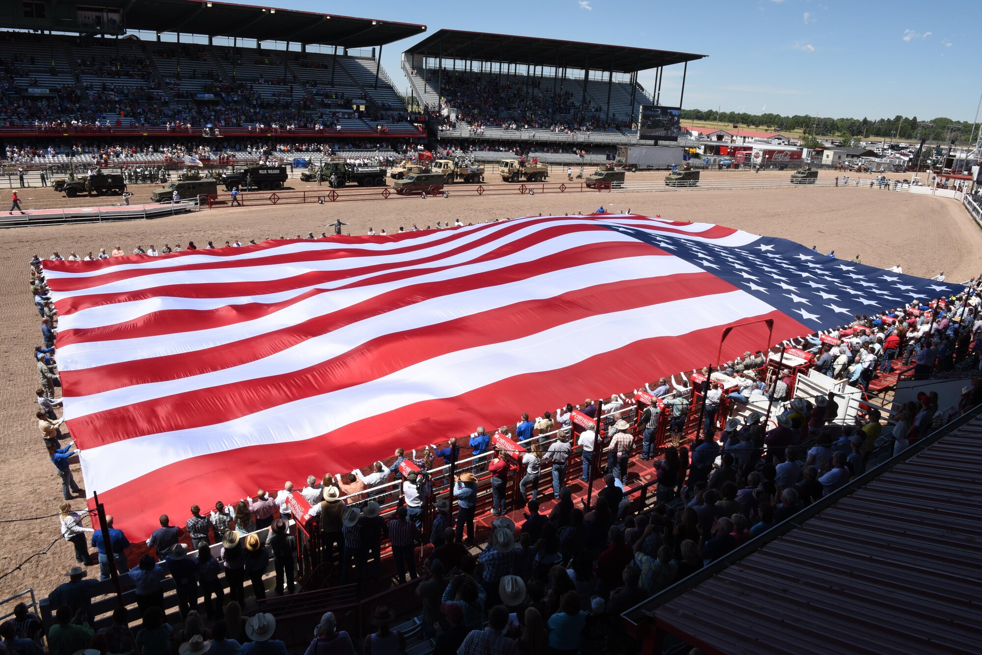 Members of the military and local community unravel the American flag at Frontier Park in Cheyenne, Wyo., July 25, 2016. The flag presentation was part of Military Monday held during Cheyenne Frontier Days every year. (U.S. Air Force photo by Airman 1st Class Breanna Carter)