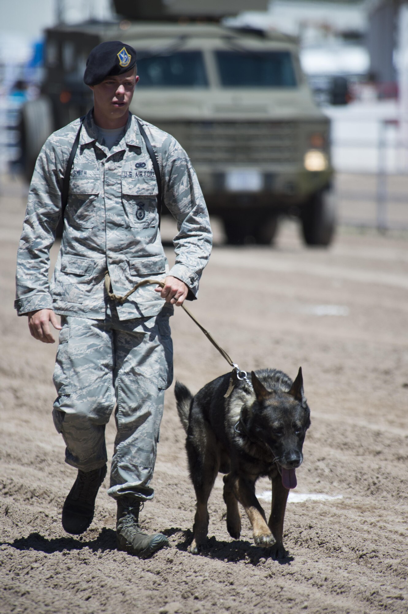 Senior Airman Daniel Smith, 90th Security Forces Squadron MWD handler, walks across Frontier Park during Military Monday in Cheyenne, Wyo., July 25, 2016. Several groups of military working dogs and their handlers were present for the event. (U.S. Air Force photo by Staff Sgt. Christopher Ruano)