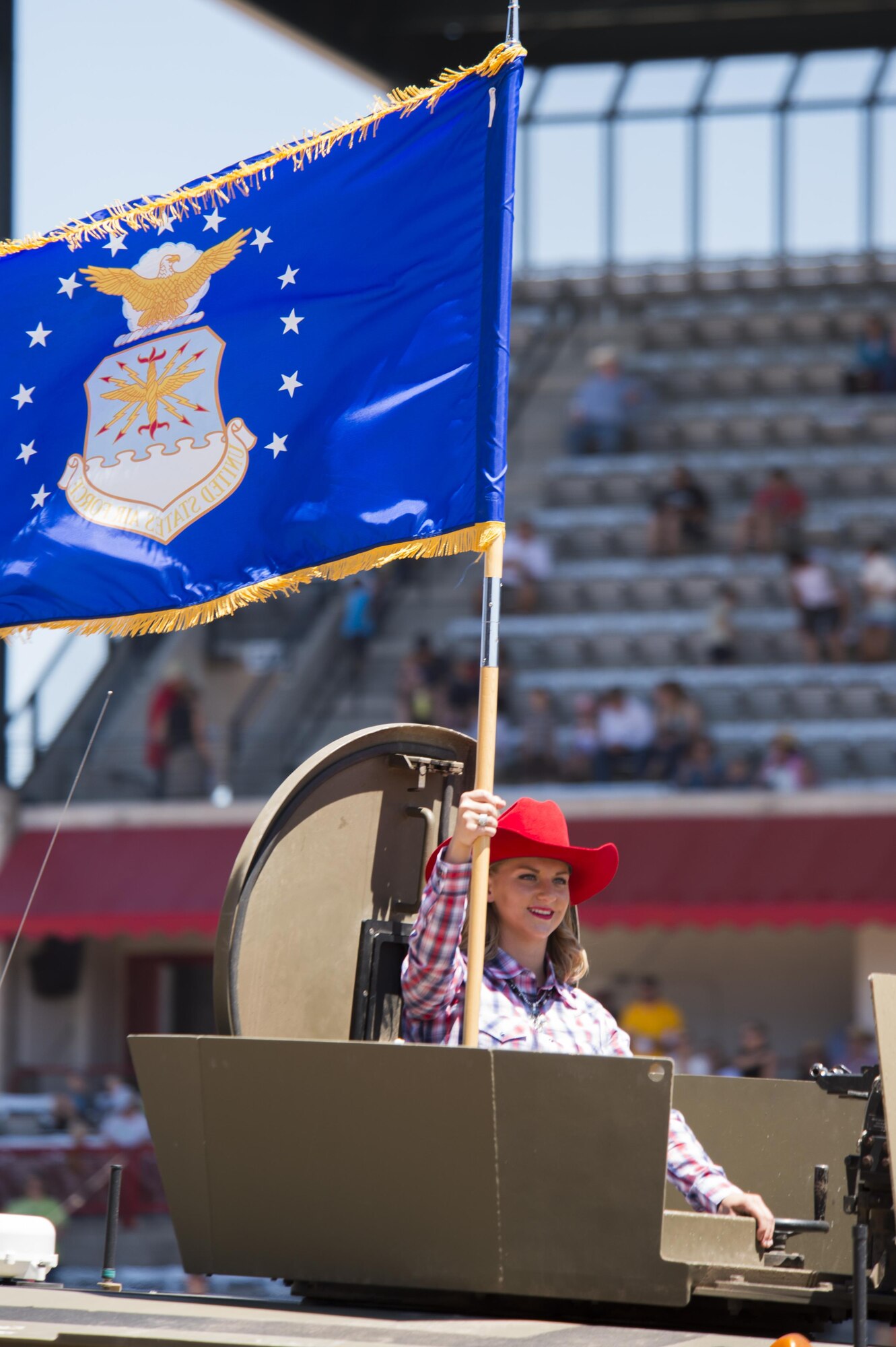 Senior Airman Alexis Visser, 90th Munitions team member, carries the US Air Force flag during Military Monday at Frontier Park in Cheyenne, Wyo., July 25, 2016. Each branch of the military was represented by a service member carrying their respective flag in a motorcade. (U.S. Air Force photo by Staff Sgt. Christopher Ruano)