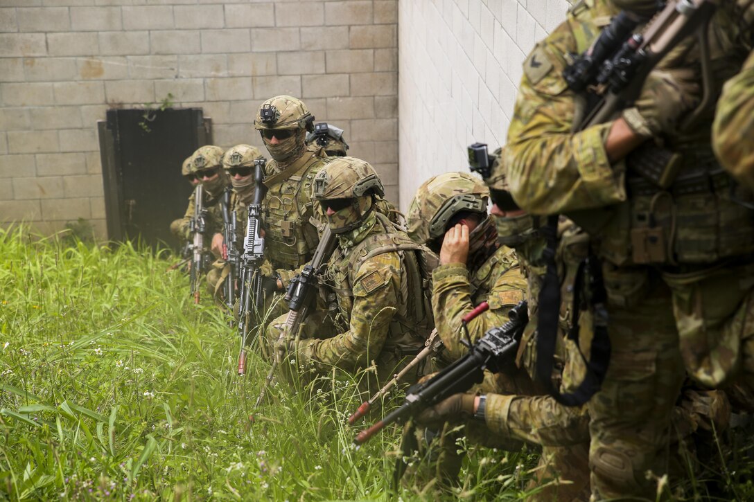 Members of the Australian Army, attached to Golf Company, 2nd Battalion, 3rd Marines, wait for the signal to begin securing a building as part of a raid during Rim of the Pacific 2016. Twenty-six nations, 49 ships, six submarines, about 200 aircraft, and 25,000 personnel are participating in RIMPAC 16 from June 29 to Aug. 4 in and around the Hawaiian Islands and Southern California. The world’s largest international maritime exercise, RIMPAC provides a unique training opportunity while fostering and sustaining cooperative relationships between participants critical to ensuring the safety of sea lanes and security on the world’s oceans. RIMPAC 16 is the 25th exercise in the series that began in 1971. 