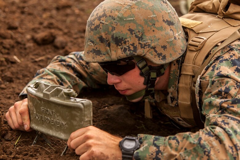 U.S. Marine Corps Lance Cpl. Kendal Kleinhenz, a combat engineer with Marine Wing Support Squadron (MWSS) 171 stationed at Marine Corps Air Station Iwakuni, Japan, deploys an M18A1 Claymore Mine during exercise Eagle Wrath 2016 at Combined Arms Training Center Camp Fuji, July 20, 2016. The squadron plans to complete their unit annual training requirements throughout three stages, which focus on air base ground defense and Marine Corps common skills that Marines are unable to train for locally. Combat engineers within the squadron also conducted training for Military Operations in Urban Terrain, which focuses on improving the individual and collective combat skills of the Marines. (U.S. Marine Corps photo by Lance Cpl. Aaron Henson)