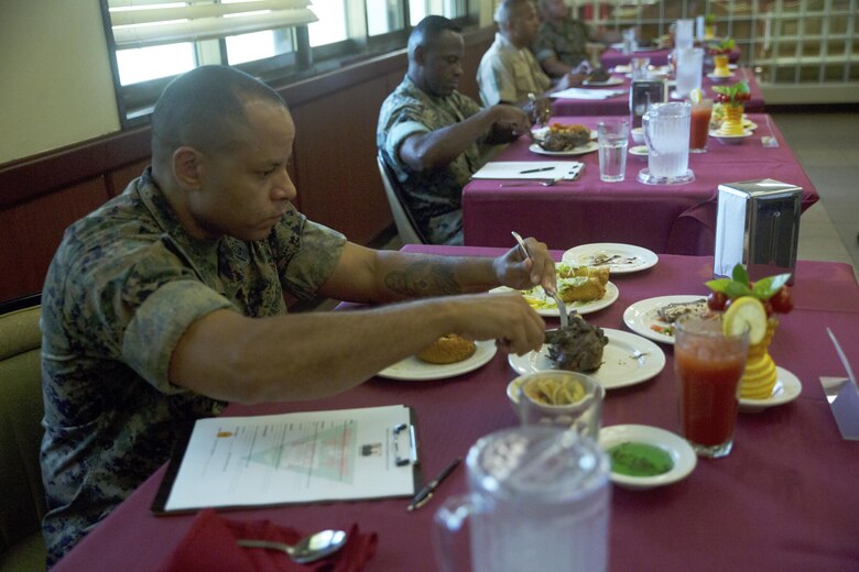 Master Gunnery Sgt. Tony C. Smith samples a lamb shank while serving on the judges panel for the Futenma Mess Hall Chef of the Month competition July 22 on Marine Corps Air Station Futenma, Okinawa, Japan. The monthly competition is an opportunity for the Marines who are performing well in the workplace and seeking opportunities to better themselves through merit boards and other events. During the competition, the contestants must plan a full multi-course meal, cook the dishes and serve it to a panel of judges who evaluate their meal based on taste, appearance, originality and the Marines’ oral presentations explaining each course. Smith is a food service specialist with Headquarters and Support Battalion, Marine Corps Installations Pacific-Marine Corps Base Camp Butler, Japan and a Columbus, Ohio, native.