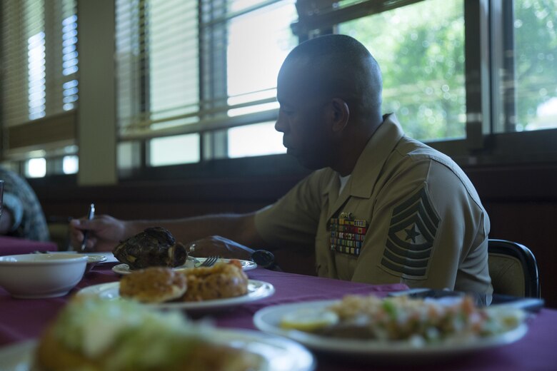 Sgt. Maj. Clement C. Pearson writes comments while serving as a judge for the Futenma Mess Hall Chef of the Month competition July 22 on Marine Corps Air Station Futenma, Okinawa, Japan. The monthly competition is an opportunity for the Marines who are performing well in the workplace and seeking opportunities to better themselves through merit boards and other events. During the competition, the contestants must plan a full multi-course meal, cook the dishes and serve it to a panel of judges who evaluate their meal based on taste, appearance, originality and the Marines’ oral presentations explaining each course. Pearson is the sergeant major of Headquarters and Headquarters Squadron, Marine Corps Air Station Futenma, and a Virginia Beach, Virginia, native.