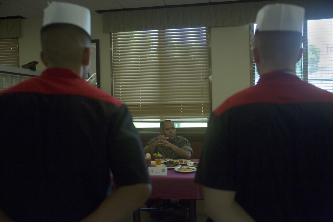Master Gunnery Sgt. Tony C. Smith gives critiques to food service specialists after receiving awards for their performance in the Futenma Mess Hall Chef of the Month competition July 22 on Marine Corps Air Station Futenma, Okinawa, Japan. The monthly competition is an opportunity for the Marines who are performing well in the workplace and seeking opportunities to better themselves through merit boards and other events. During the competition, the contestants must plan a full multi-course meal, cook the dishes and serve it to a panel of judges who evaluate their meal based on taste, appearance, originality and the Marines’ oral presentations explaining each course. Smith is a food service specialist with Headquarters and Support Battalion, Marine Corps Installations Pacific-Marine Corps Base Camp Butler, Japan and a Columbus, Ohio, native.