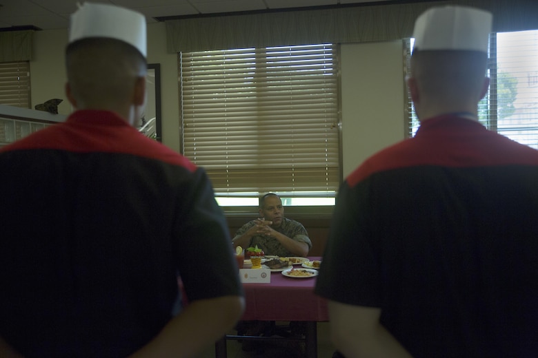 Master Gunnery Sgt. Tony C. Smith gives critiques to food service specialists after receiving awards for their performance in the Futenma Mess Hall Chef of the Month competition July 22 on Marine Corps Air Station Futenma, Okinawa, Japan. The monthly competition is an opportunity for the Marines who are performing well in the workplace and seeking opportunities to better themselves through merit boards and other events. During the competition, the contestants must plan a full multi-course meal, cook the dishes and serve it to a panel of judges who evaluate their meal based on taste, appearance, originality and the Marines’ oral presentations explaining each course. Smith is a food service specialist with Headquarters and Support Battalion, Marine Corps Installations Pacific-Marine Corps Base Camp Butler, Japan and a Columbus, Ohio, native.