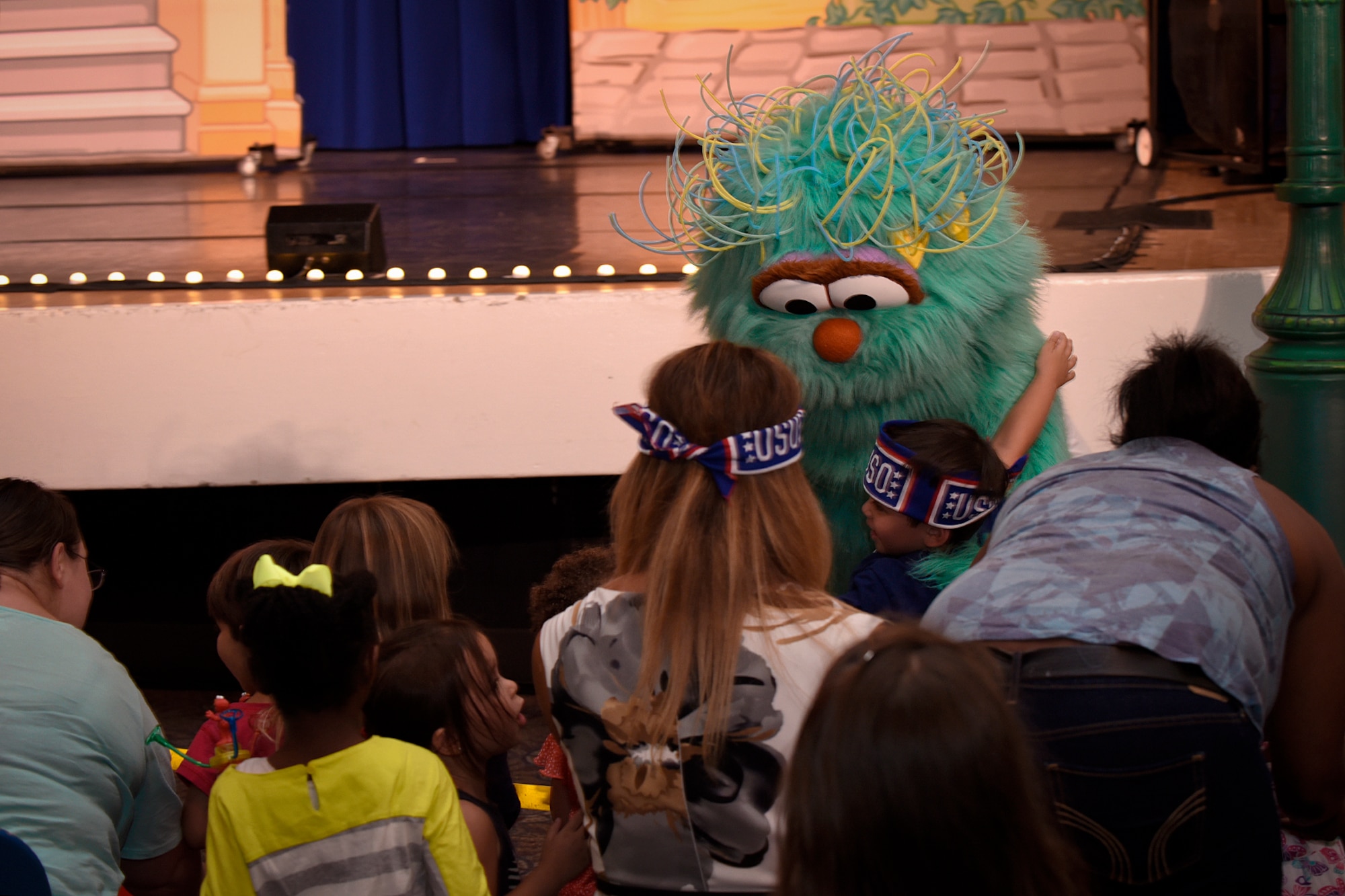 PETERSON AIR FORCE BASE, Colo. – Peterson youth embrace Sesame Street’s Rosita during the Sesame Street USO Experience at the base auditorium on Peterson Air Force Base, Colo., July 22, 2016. The experience delivered a message of encouragement during challenges of military life to local military families. (U.S. Air Force photo by Senior Airman Rose Gudex)