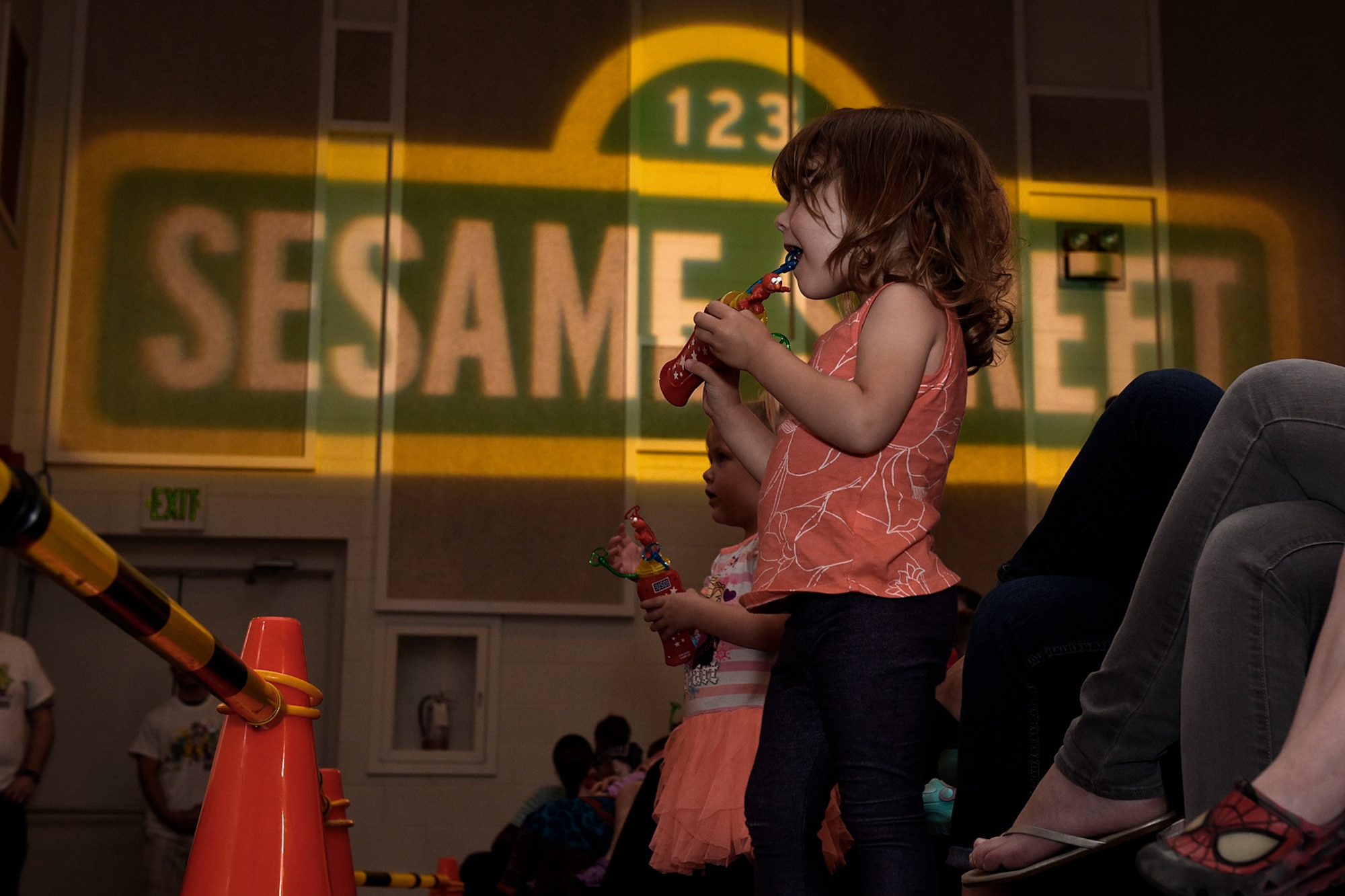 PETERSON AIR FORCE BASE, Colo. – Emmalin Mooberry, 3, watches in awe as the Sesame Street characters dance during the Sesame Street USO Experience at the base auditorium on Peterson Air Force Base, Colo., July 22, 2016. Sesame Street and the USO brought the furry muppets to Peterson to teach kids about how to make friends during a military move. (U.S. Air Force photo by Senior Airman Rose Gudex)