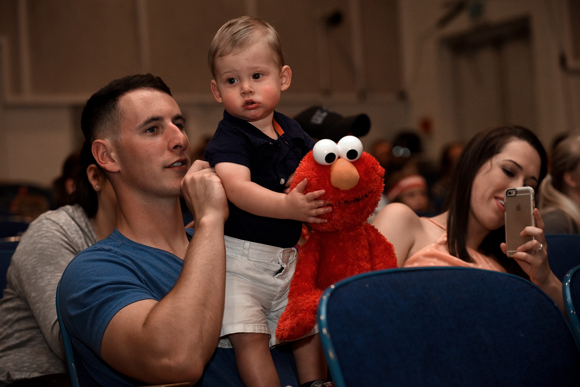 PETERSON AIR FORCE BASE, Colo. – Staff Sgt. Nick Pontieri, 50th Security Forces Squadron at Schriever Air Force Base, watches the Sesame Street USO Experience with his son, Brantley, at the base auditorium on Peterson Air Force Base, Colo., July 22, 2016. Sesame Street teams up with the USO every year to bring “Moving,” a show about a military child on Sesame Street moving to a new base, to military families around the world. (U.S. Air Force photo by Senior Airman Rose Gudex)