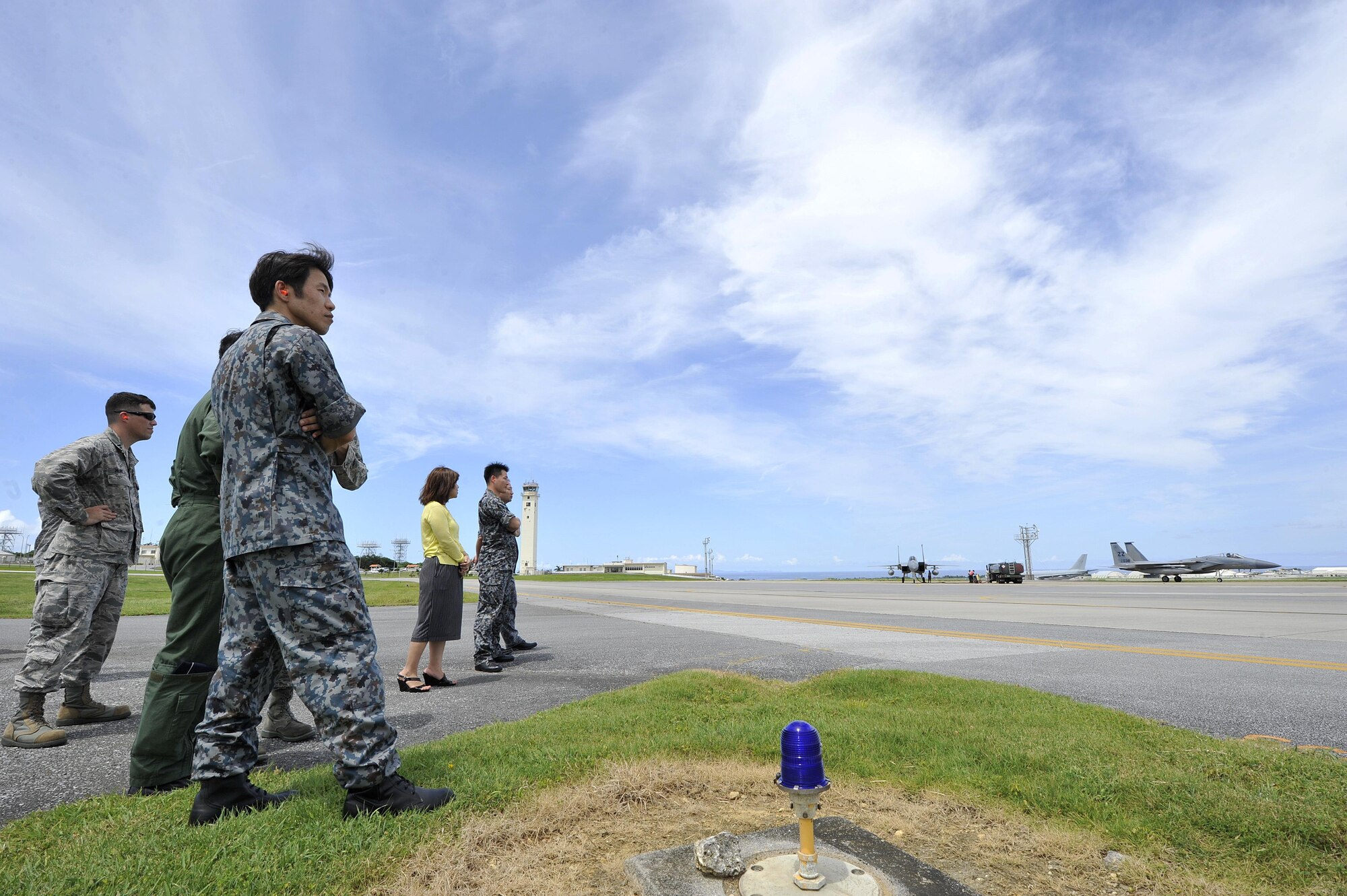 Japan Air Self Defense Force officers from Naha Air Base, Okinawa, observe the 18th Logistics Readiness Squadron fuels flight distribute to F-15 Eagles during their tour, July 21, 2016, at Kadena Air Base, Japan. The 18th LRS and JASDF officers toured the Kadena Petroleum, oils, and lubricants facilities, Fuel Service Center, and Distribution Management section while also observing hot pit refueling operations. (U.S. Air Force photo by Naoto Anazawa)