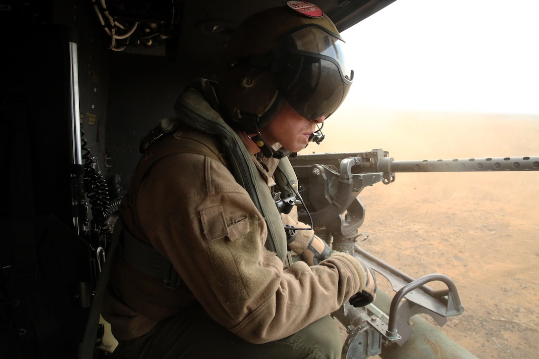 Cpl. Christopher Neumann relays distance-to-ground information to UH-1Y pilots during a close air support exercise at Pohakuloa Training Area, Hawaii, July 19, 2016. Neumann is participating in Rim of the Pacific 2016, a multinational military exercise, from June 29 to Aug. 8 in and around the Hawaiian Islands. RIMPAC offers the U.S. military the opportunity to train with partners and allies in the Pacific region. Neumann, a native of Wells, Maine, is a UH-1Y Huey crew chief with Marine Light Attack Helicopter Squadron 367, which supports III Marine Expeditionary Force. (U.S. Marine Corps Photo by Cpl. Natalie A. Dillon)