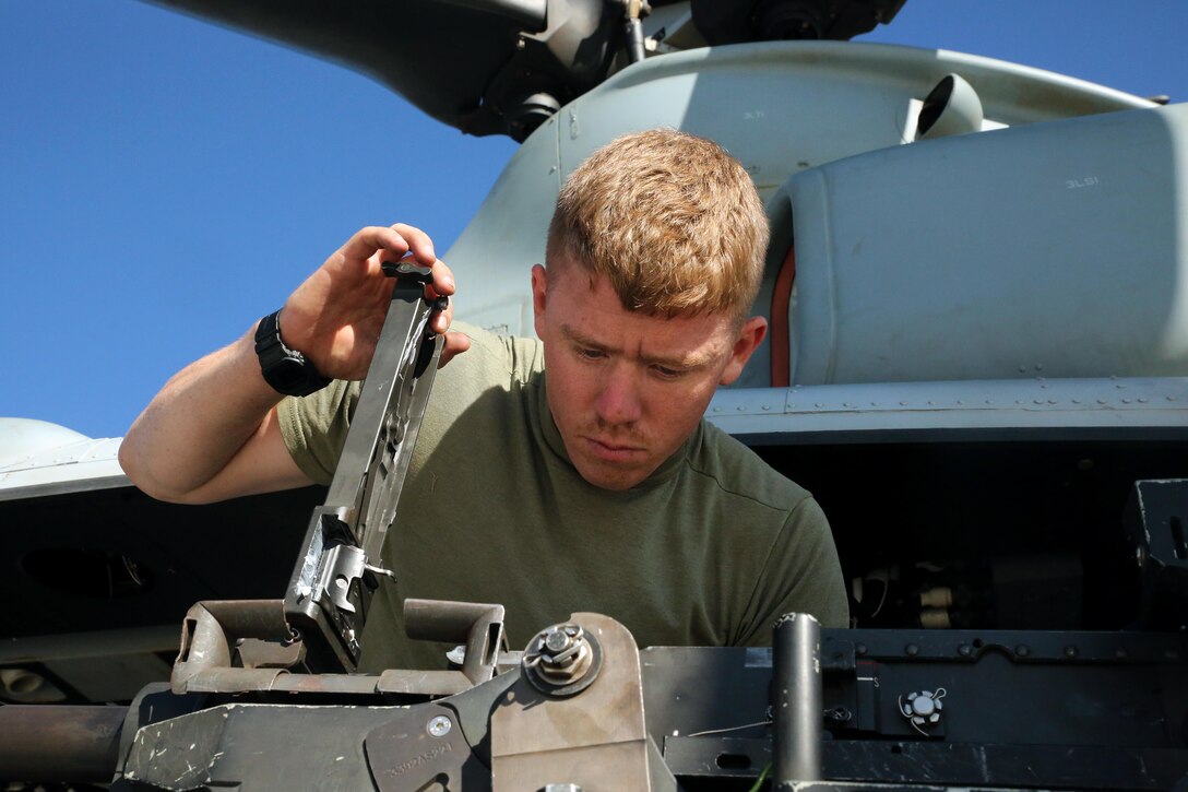 160719-M-ND832-025 POHAKULOA TRAINING AREA, Hawaii (July 19, 2016) – Cpl. Christopher Neumann inspects a GAU-21 .50 caliber machine gun before a close air support exercise at Pohakuloa Training Area, Hawaii, July 19, 2016. Neumann is participating in Rim of the Pacific 2016, a multinational military exercise, from June 29 to Aug. 8 in and around the Hawaiian Islands. RIMPAC offers the U.S. military the opportunity to train with partners and allies in the Pacific region. Neumann, a native of Wells, Maine, is a UH-1Y Huey crew chief with Marine Light Attack Helicopter Squadron 367, which supports III Marine Expeditionary Force. (U.S. Marine Corps Photo by Cpl. Natalie A. Dillon)