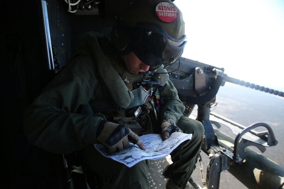 Cpl. Christopher Neumann reviews his objectives during a close air support exercise at Pohakuloa Training Area, Hawaii, July 19, 2016. Neumann is participating in Rim of the Pacific 2016, a multinational military exercise, from June 29 to Aug. 8 in and around the Hawaiian Islands. RIMPAC offers the U.S. military the opportunity to train with partners and allies in the Pacific region. Neumann, a native of Wells, Maine, is a UH-1Y Huey crew chief with Marine Light Attack Helicopter Squadron 367, which supports III Marine Expeditionary Force. (U.S. Marine Corps Photo by Cpl. Natalie A. Dillon)
