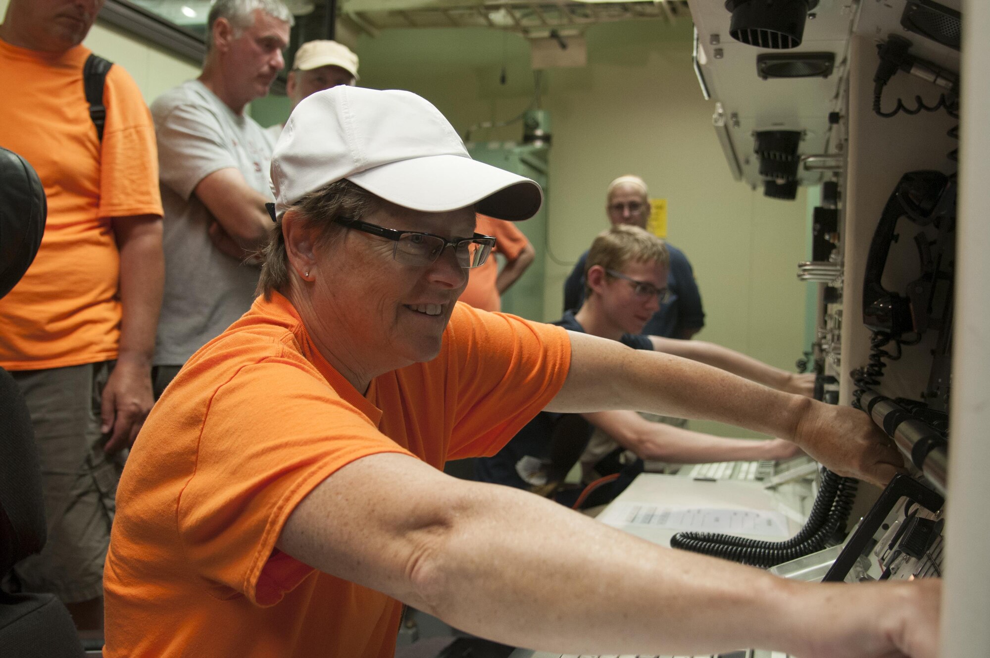 Dawn Russert, visitor to F.E. Warren Air Force Base, Wyo., from Manteno, Ill., "turns keys" in a simulated launch sequence in the 90th Operations Support Squadron Missile Procedures Trainer July 24, 2016, during Fort D.A. Russell Days, the annual base open house. Base guests were shown an example of the launch sequence for the Minuteman III Intercontinental Ballistic Missile and had a hands-on role in the key turn portion, which sends a launch vote to the missile. (U.S. Air Force photo by Senior Airman Jason Wiese)