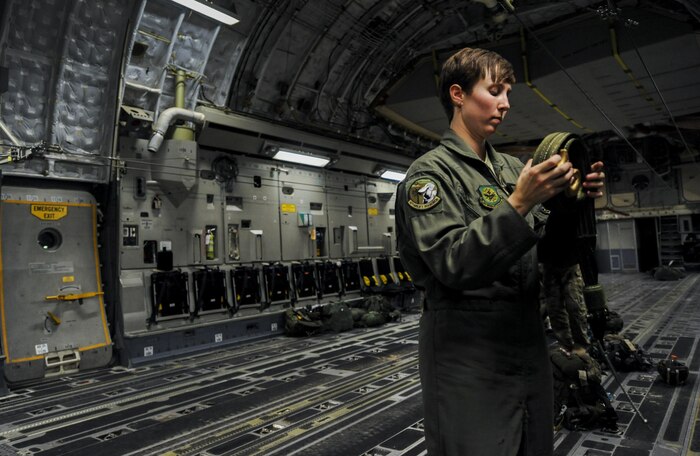 Senior Airman Ashley Igalo, 437th Airlift Wing, Joint Base Charleston, S.C., loadmaster, prepares the interior of a C-17 for Survival Evasion Resistance Escape specialist’s static line jumps during Red Flag 16-3 at Nellis Air Force Base, Nev., July 20, 2016. All four branches of the U.S. Military participate in the Red Flag training conducted on the vast bombing and gunnery ranges of the Nevada Test and Training Range. (U.S. Air Force photo by Airman 1st Class Kevin Tanenbaum/Released)